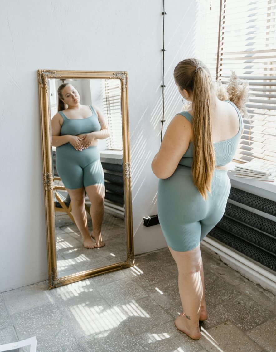 woman looking in mirror