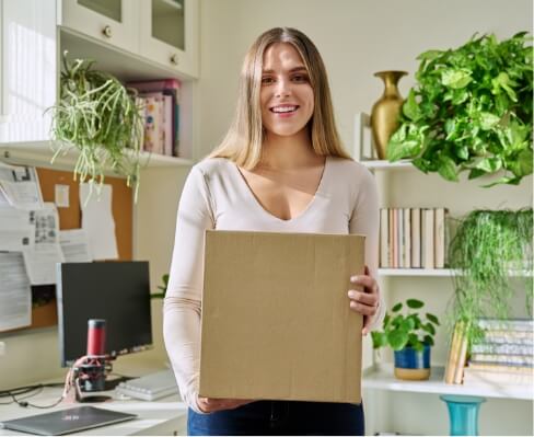 young-woman-at-home-unpacks-cardboard-box-with-onl-2024-12-08-05-26-44-utc (2)